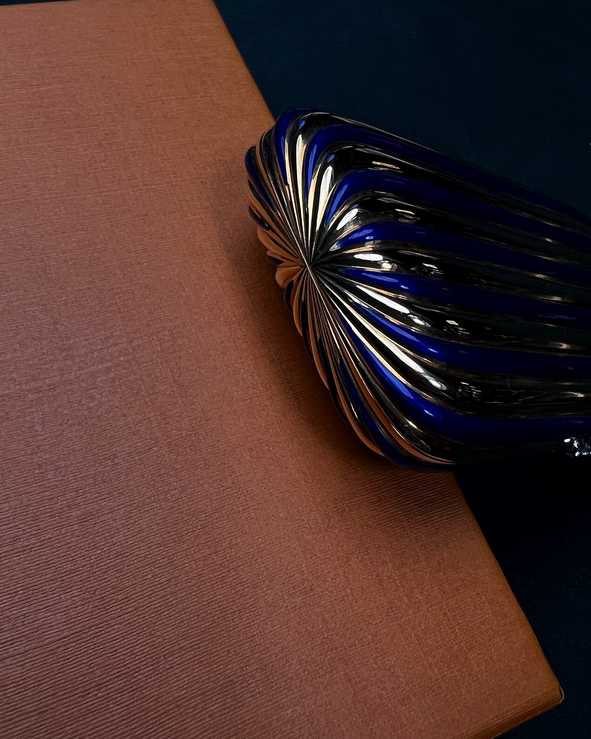 Blue shell vintage lighter on a quiet salon surface